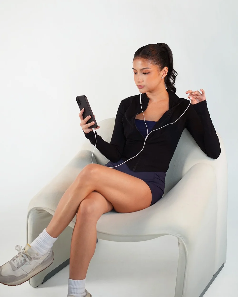 Checking her phone in the Celeste zip jacket